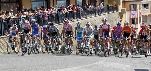 Riders stand up out of their saddles on the ascent