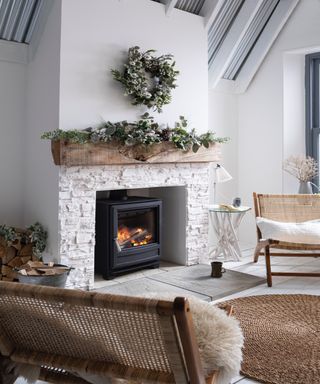 White brick fireplace with natural wreath over mantel