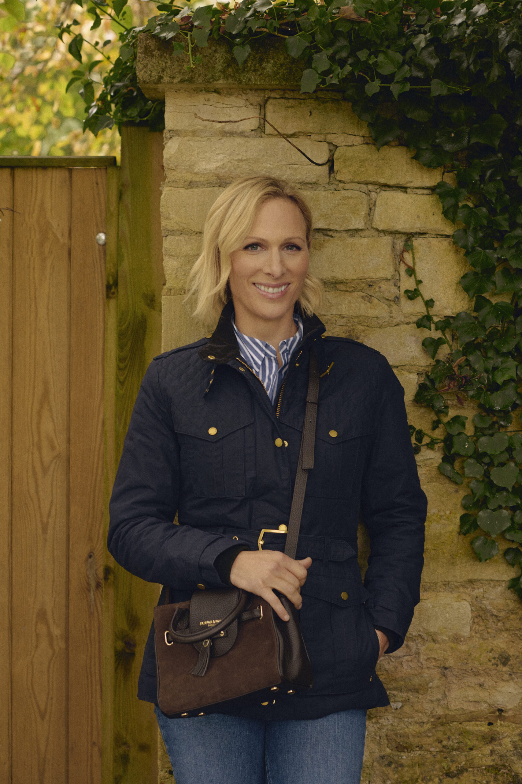 Zara Tindall official brand ambassador wearing Fairfax &amp;amp; Favor Ivy waxed jacket and Mini Windsor bag.