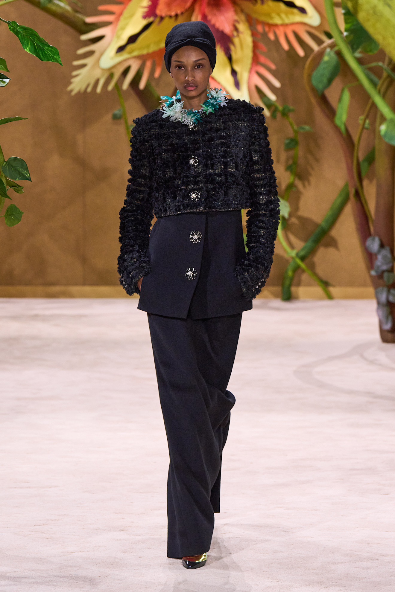 A model walking in the Chanel F/W 26 Haute Couture Show in Paris wearing metallic heels.