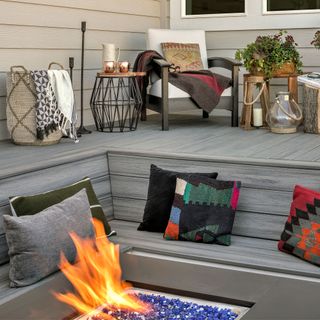 outdoor space with grey floor and copper cups on stool