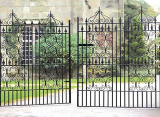 Traditional wrought iron gates to driveway to period home