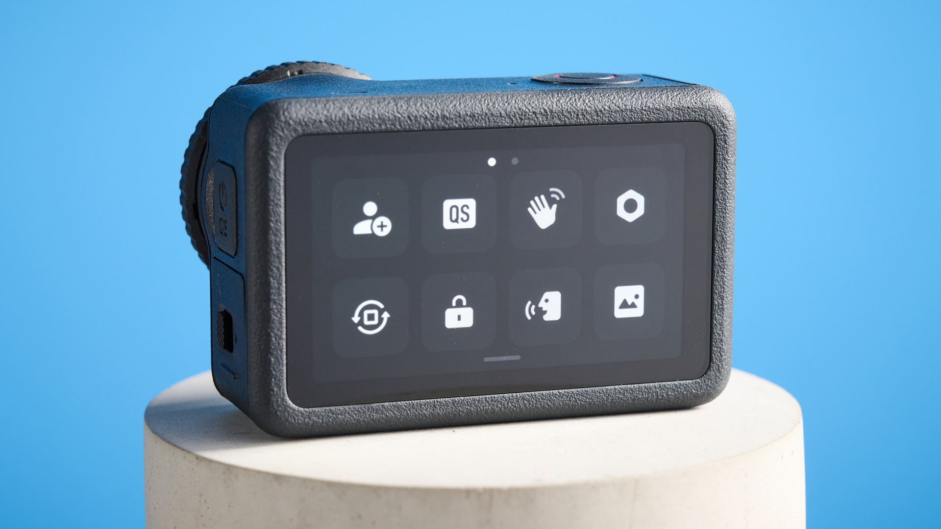 The DJI Osmo Action 6 on a stone surface with a blue background