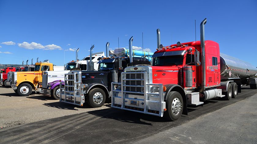 Trucks lined up parked together.