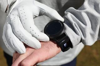 The GolfBuddy Aim W11 GPS Watch on a golfers wrist