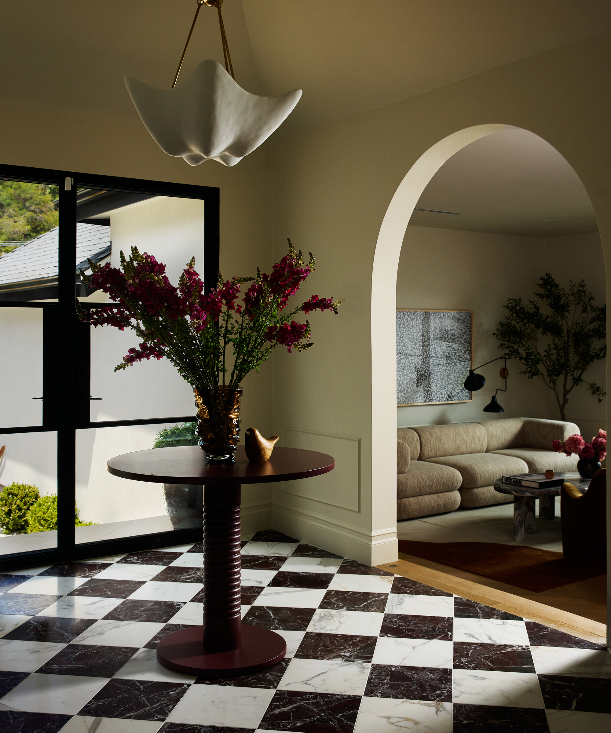 entryway with checkerboard floor and central round table