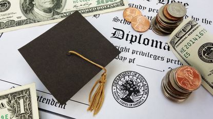 Graduation cap and money sitting on top of a diploma 