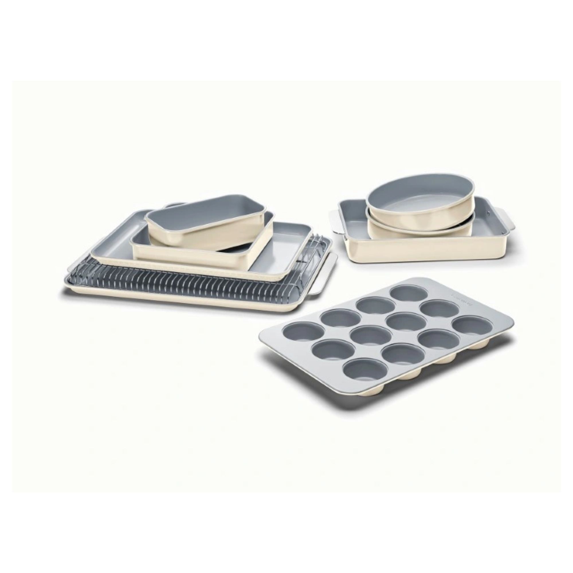 A complete set of cream bakeware, including baking trays, cake tins, roasting tin, muffin tin, and a loaf tin.
