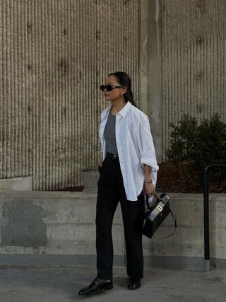woman wearing loafers with trousers, tank, and button-down shirt