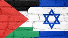 The Israeli and Palestinian flags painted on a brick wall