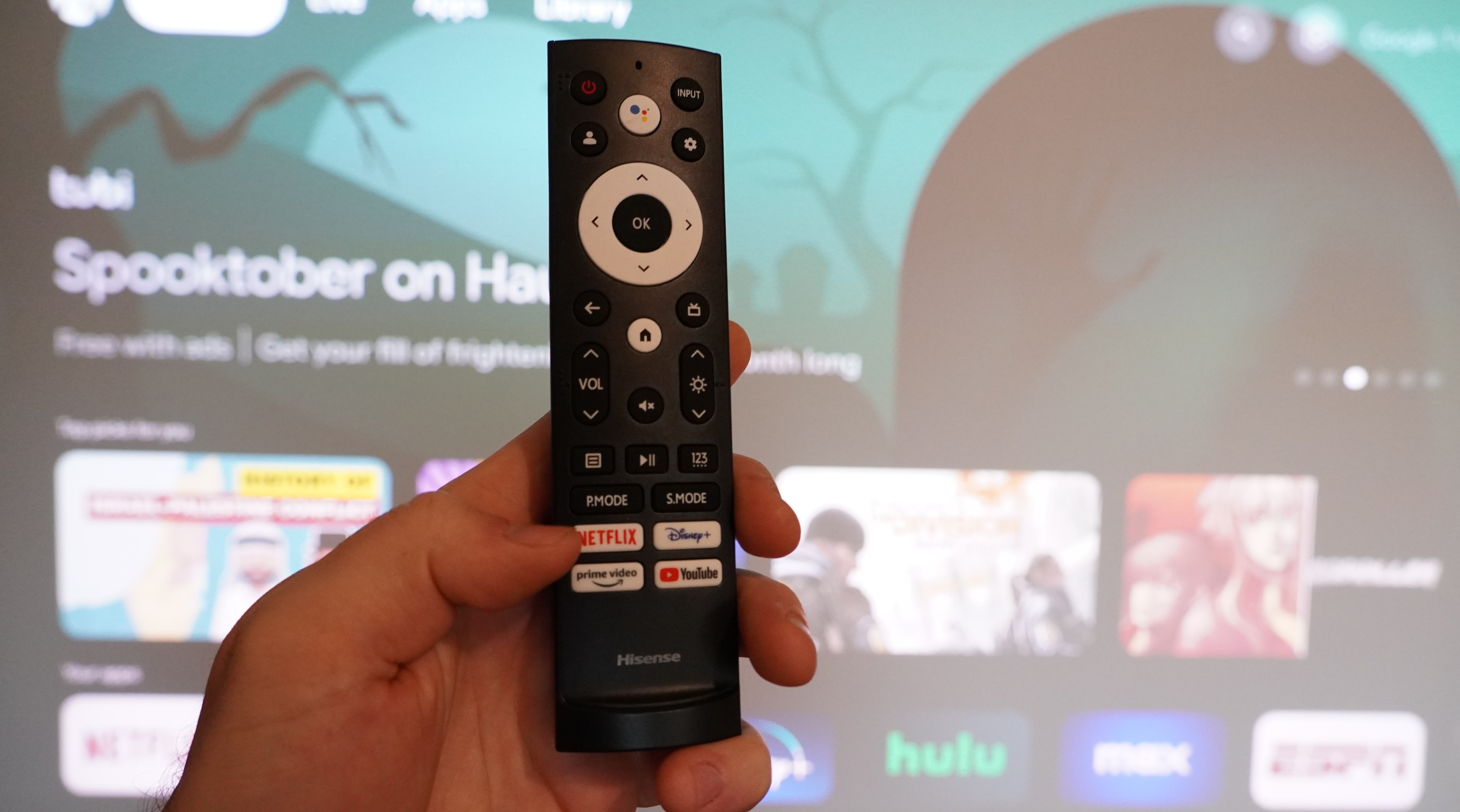 Hisense PX2-Pro remote control held in reviewer''s hand