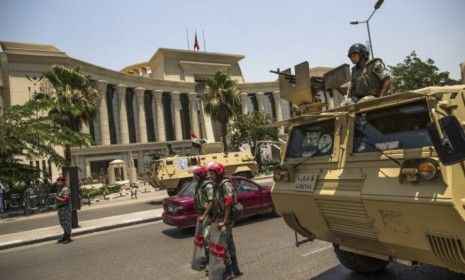 Egyptian military police stand guard during a protest against presidential candidate Ahmed Shafik outside the Supreme Constitutional Court on June 14 in Cairo: The court&amp;#039;s ruling &amp;quot;isn&amp;#039;t a dea