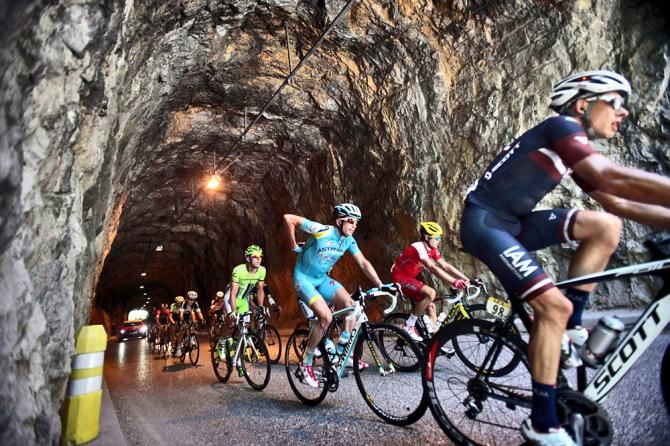 The peloton passes through one of many tunnels on route