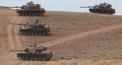 Turkish Armed Forces tanks head to the Syrian border in this file photo