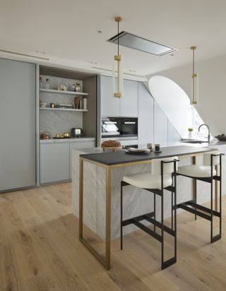 blue kitchen in a apartment loft space, modern elements and black bar stools