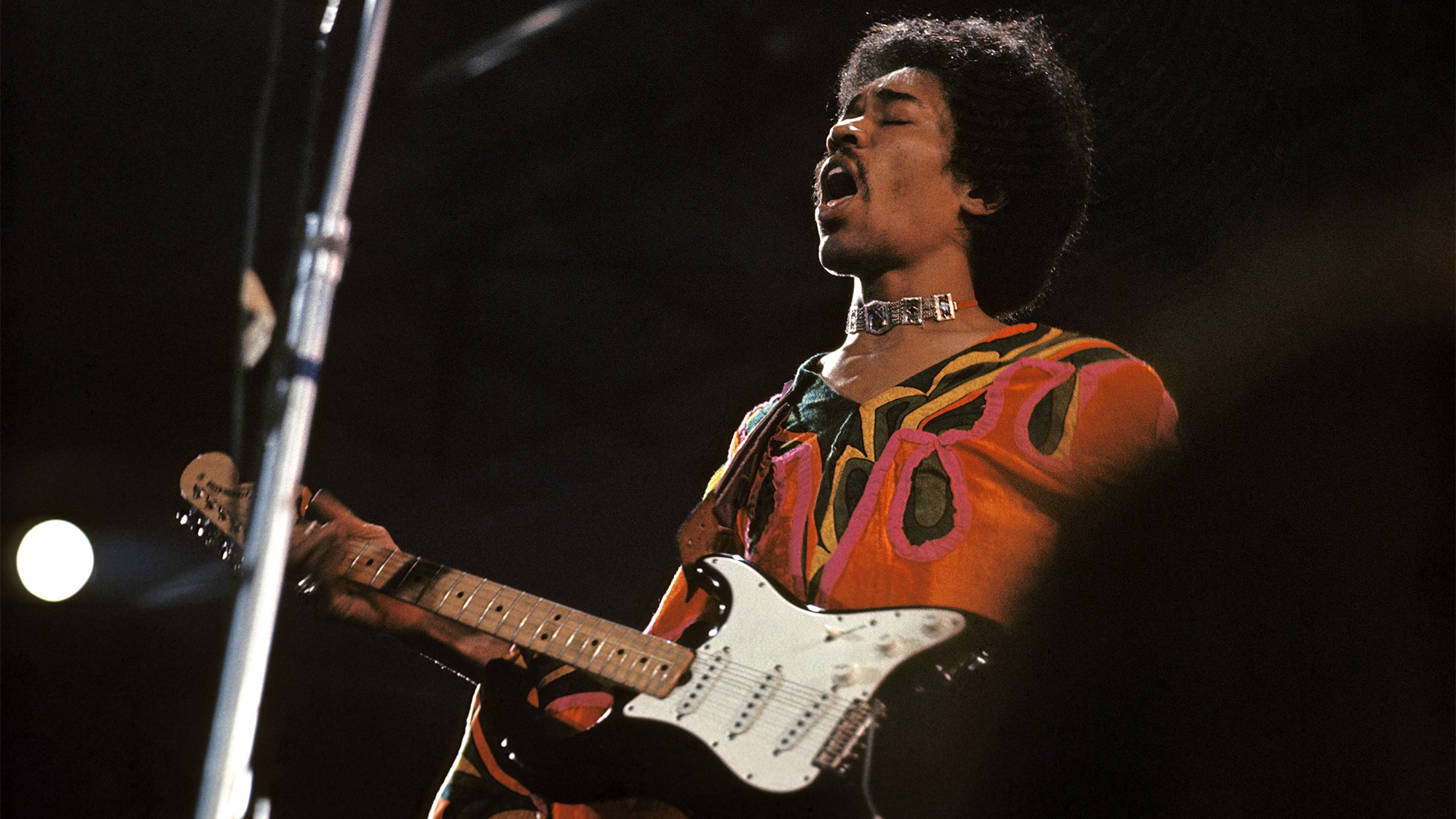 Jimi Hendrix performs live on stage playing a black Fender Stratocaster guitar at the 1970 Isle of Wight Festival at Afton Down on the Isle of Wight on the night of 30th-31st August 1970.