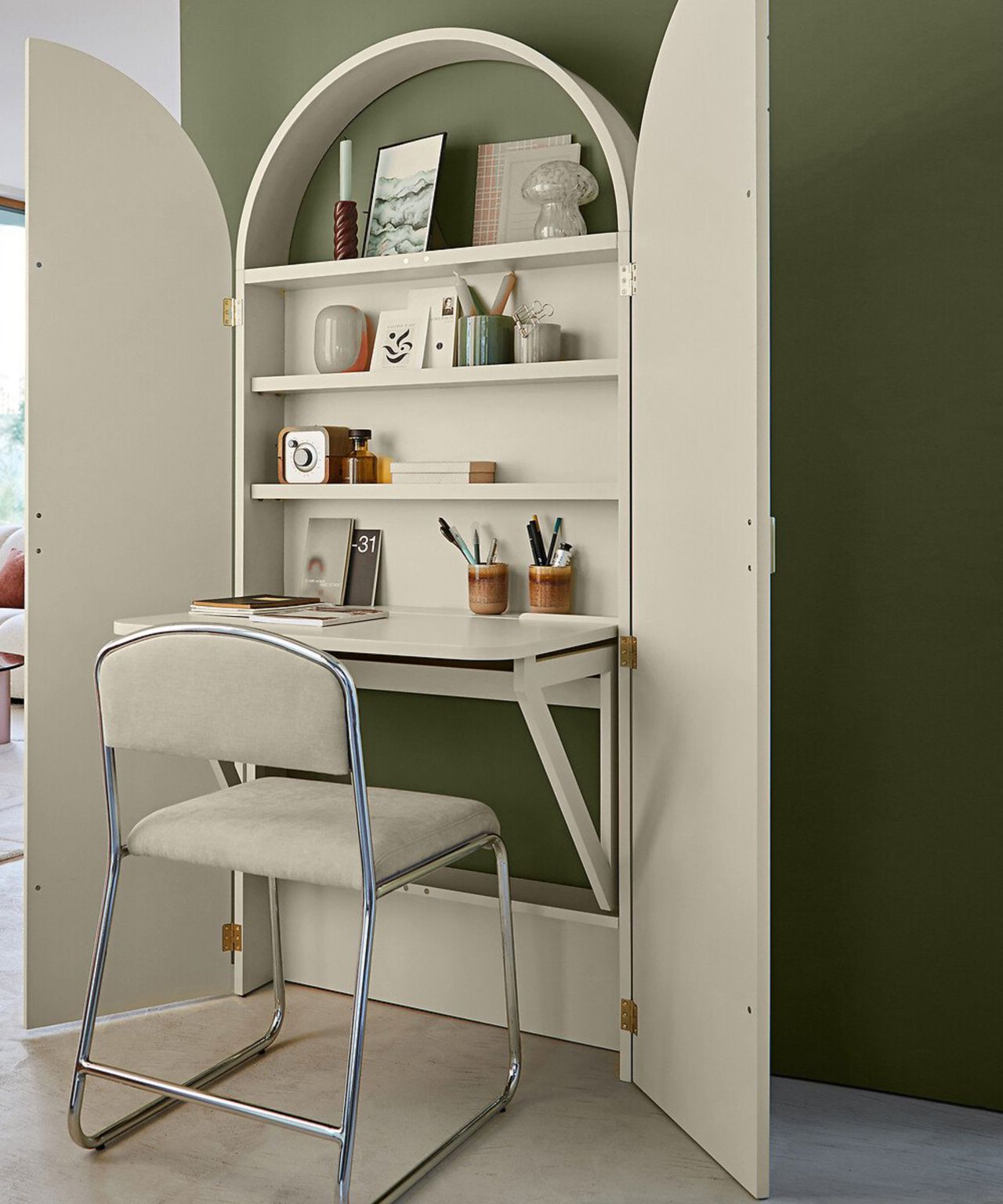 cream hideaway desk against green wall opened up with cream desk chair in front of desk