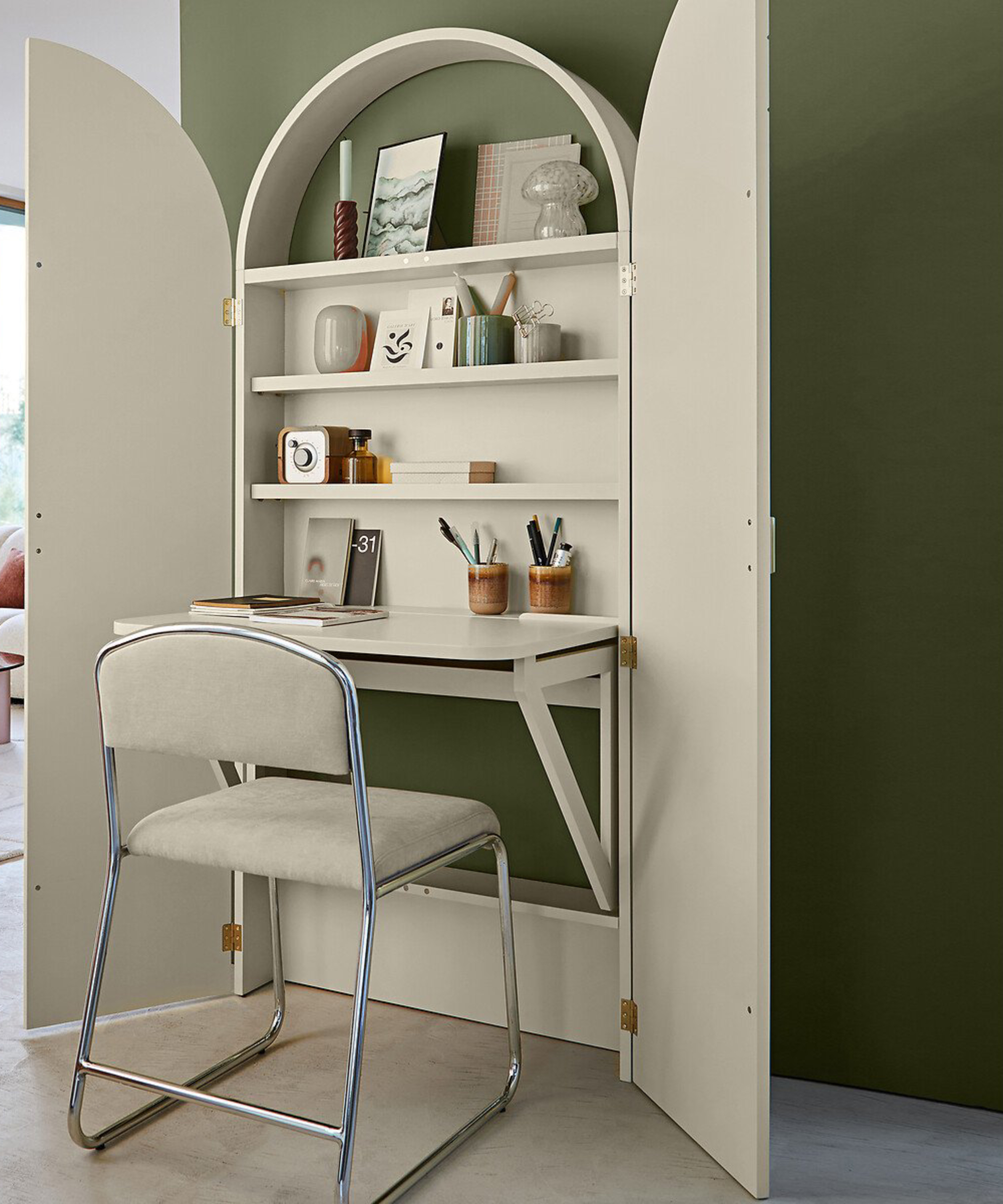 cream hideaway desk against green wall opened up with cream desk chair in front of desk