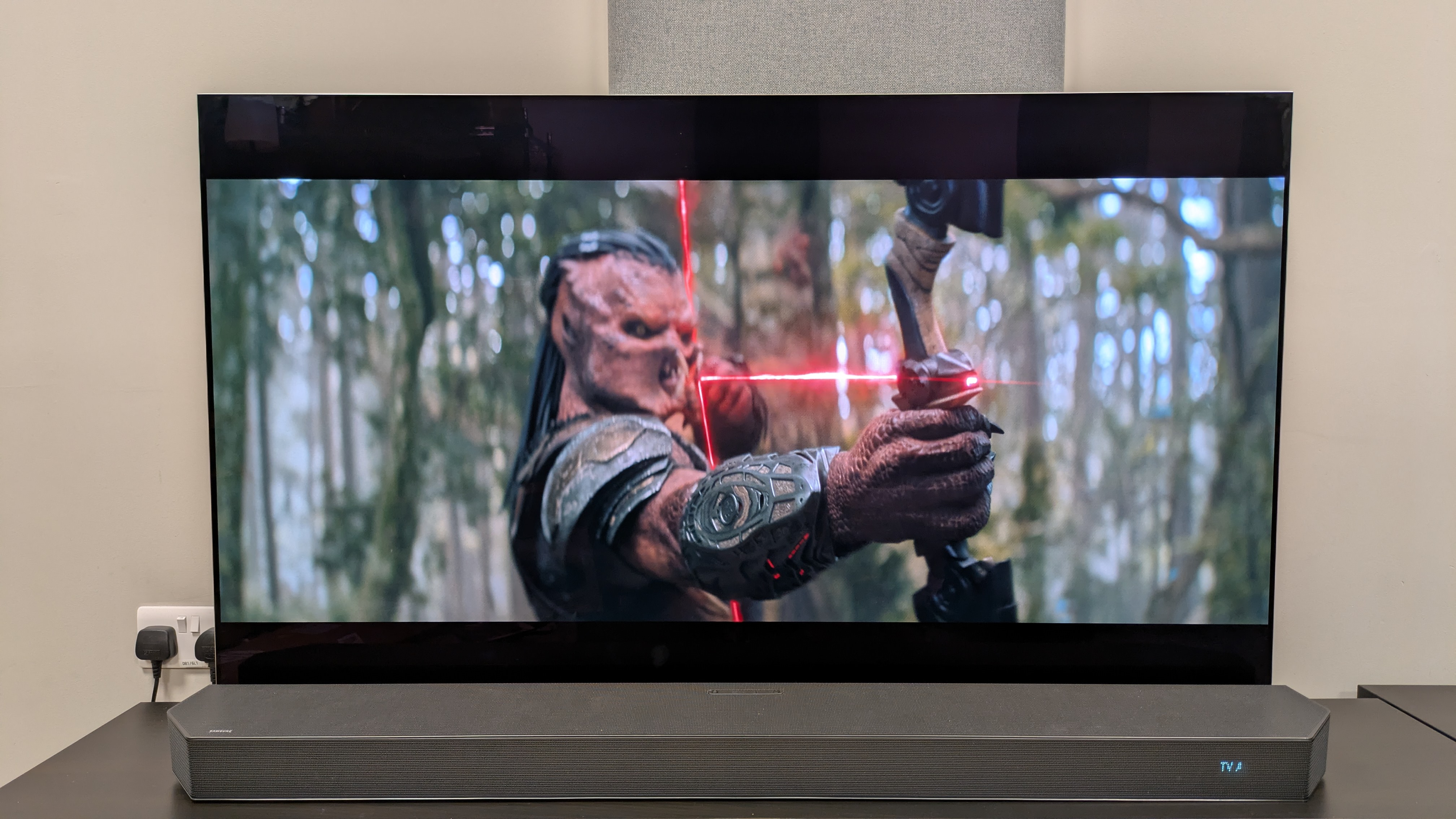 Predator: Badlands 4K Blu-ray on LG G5 showing Dek pulling back on a bow 