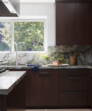Black kitchen with white marble worktop