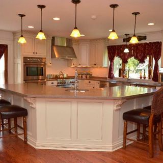 kitchen room with hanging light and wooden flooring