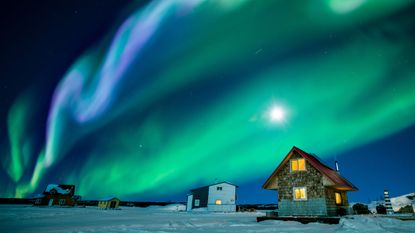 Northern lights glow green and purple above Great Slave Lake in the Northwest Territories of Canada.