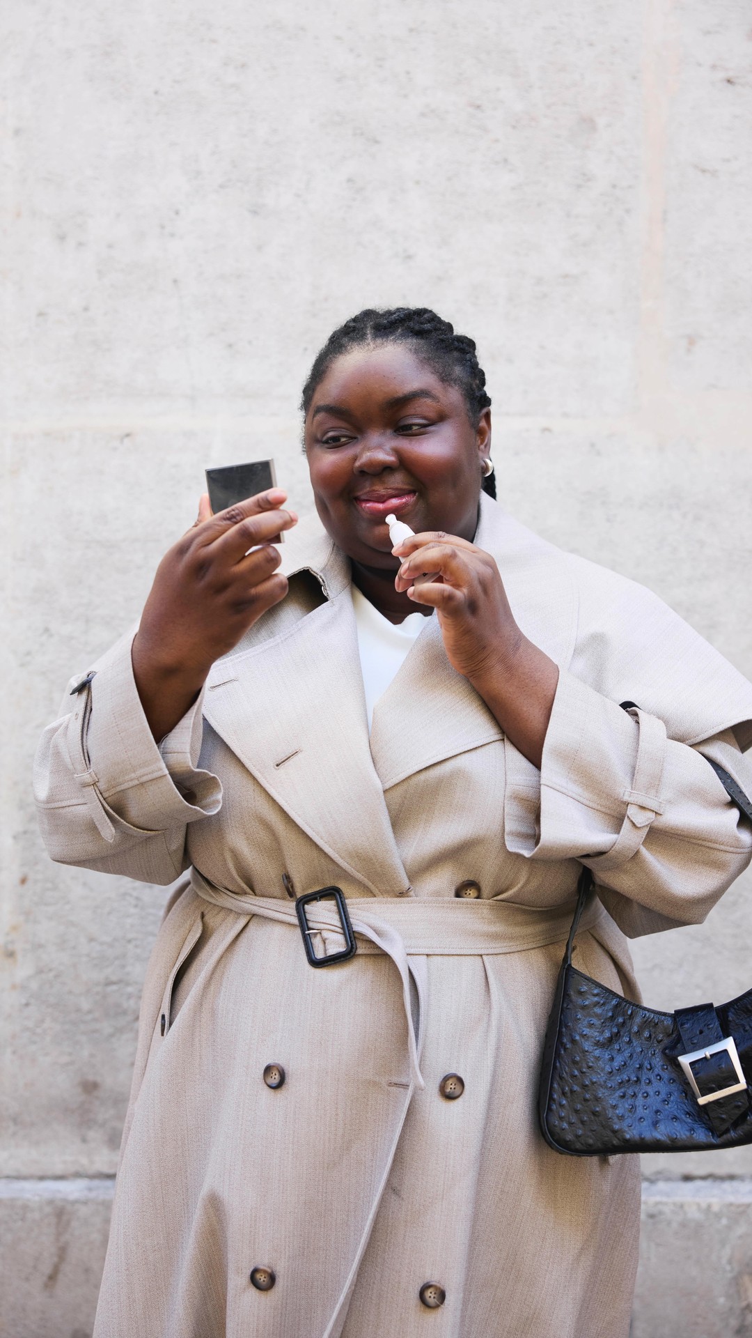 An image of @abimarvel wearing a trench coat.