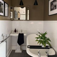 bathroom with bathtub mirror on wall with wash basin 