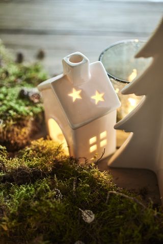 Christmas table gift idea, ceramic tealight holder nestled in moss on a table