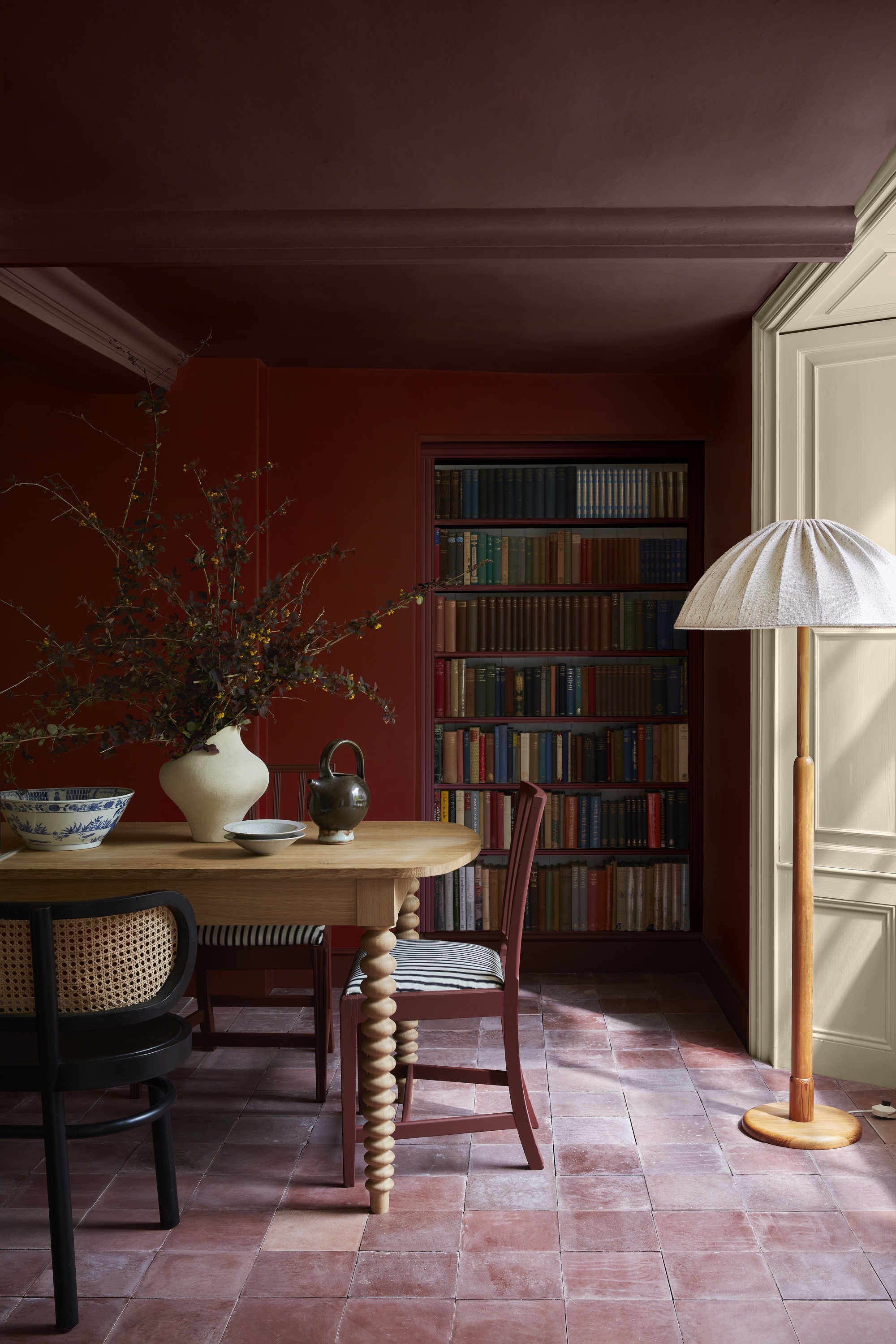 burgundy dining room with cream accent wall