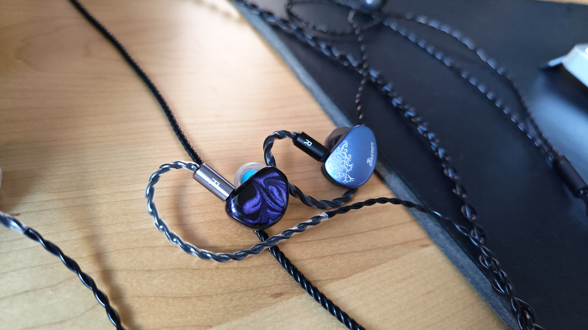 The Kiwi Ears Cadenza II in-ear monitors on a home desktop. 