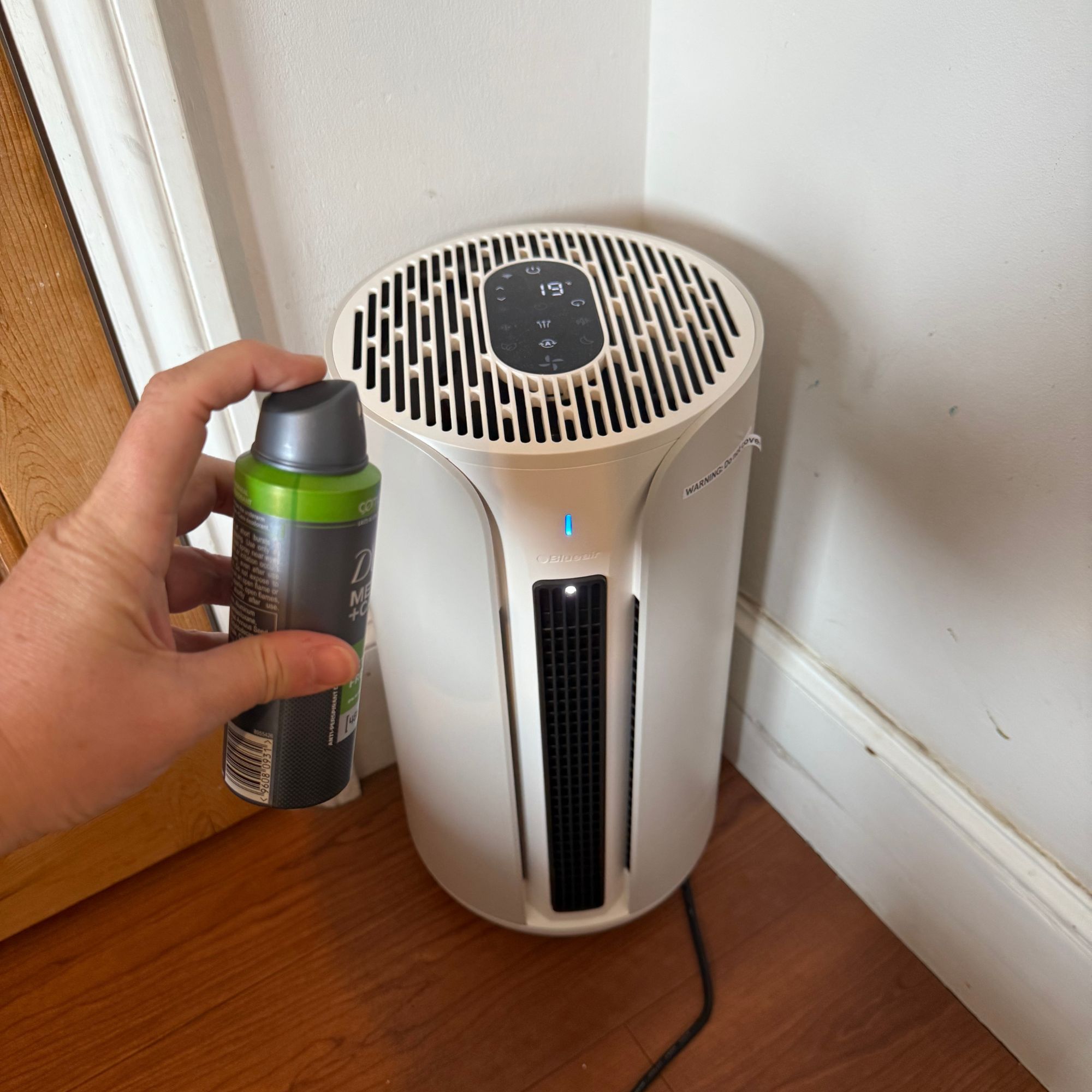 Spraying deodorant in front of the Blueair ComfortPure 3-in-1 T10i Air Purifier