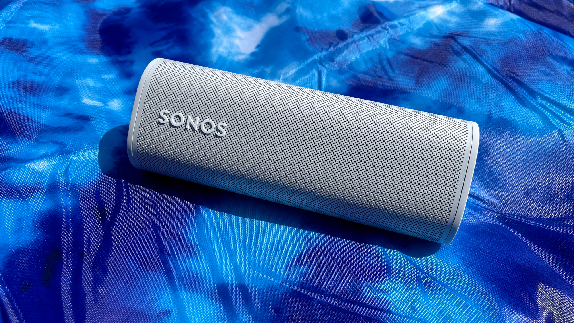 The Sonos Roam pictured behind a watery backdrop