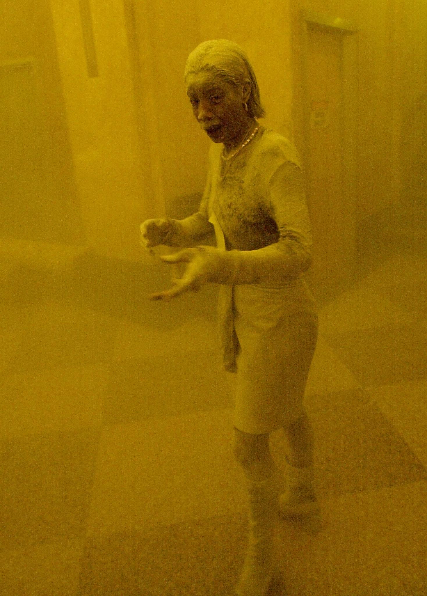 This 11 September 2001 file photo shows Marcy Borders covered in dust as she takes refuge in an office building after one of the World Trade Center towers collapsed in New York. Borders was caught outside on the street as the cloud of smoke and dust enveloped the area. The woman was caught outside on the street as the cloud of smoke and dust enveloped the area. AFP PHOTO/Stan HONDA (Photo by STAN HONDA / AFP)