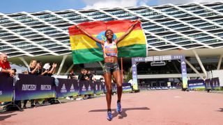 Adidas athlete Senbere Teferi holding the Ethiopian flag right after she broke the women's only 5k world record