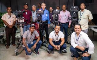 Luis Aquino (standing 2nd from right) and CERTV colleagues with Ikegami's Alan Keil (mid-blue shirt) and Oscar Vaca (light blue shirt) plus the four new UHK-X700 cameras.