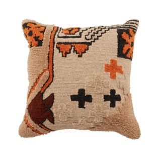 A tufted orange and earth toned pillow