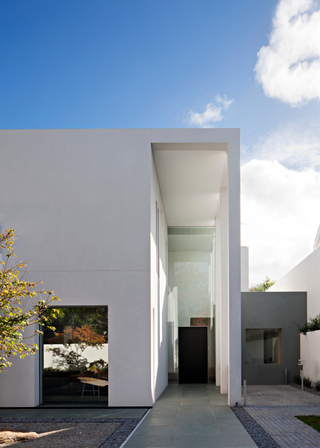 A large paved entryway leading to a black front door