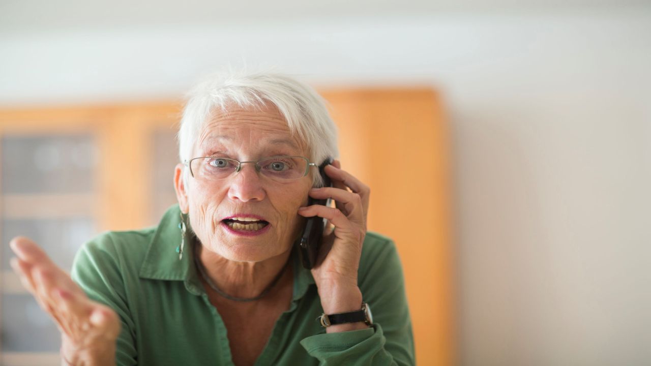 A person who is angry and on the telephone.