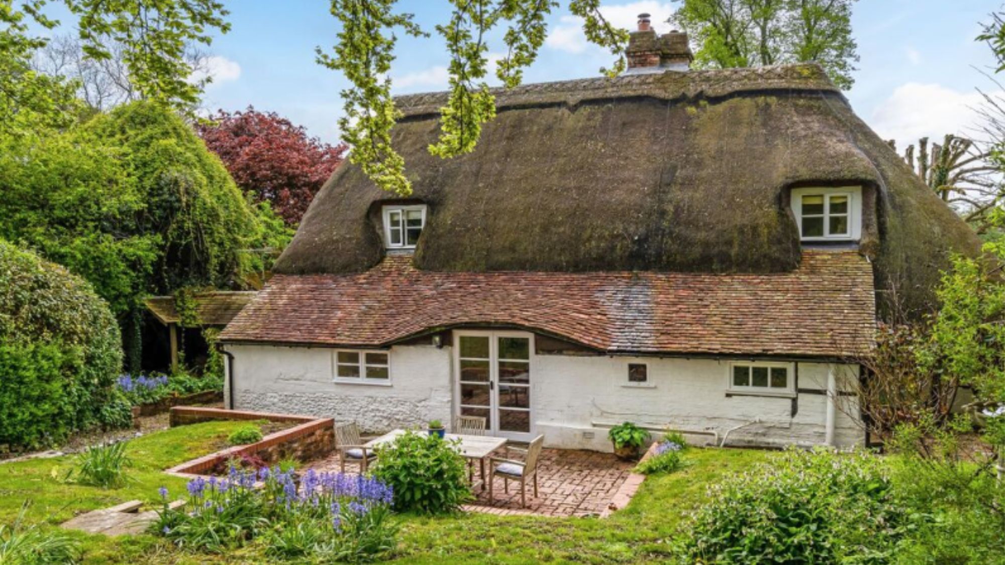 long cottage/farm house with a garden