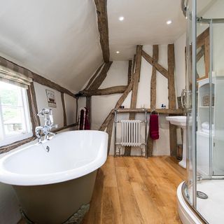 bathroom with wooden beams and bathtub