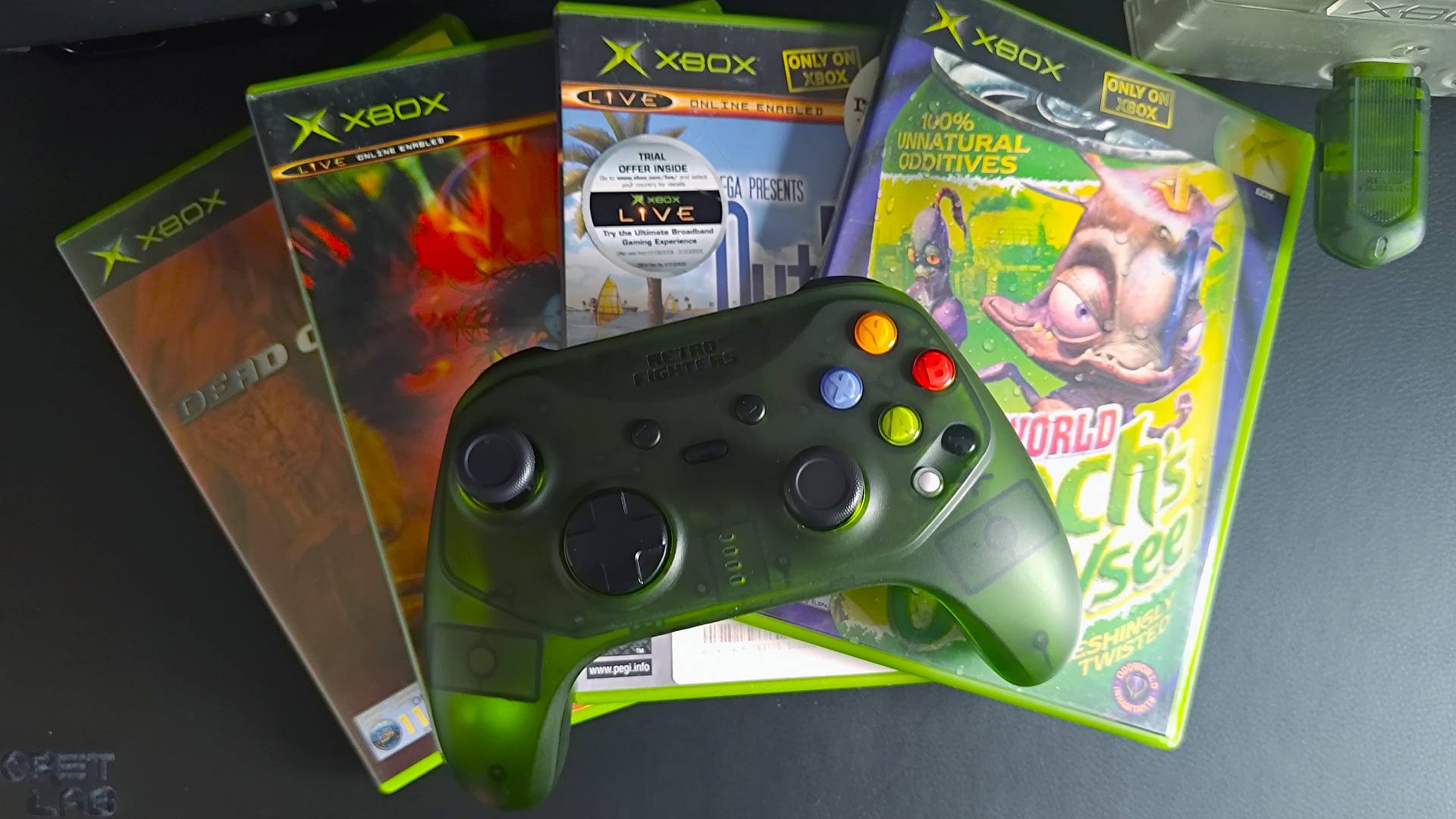 Retro Fighters Hunter on top of OG Xbox games (Oddworld: Munch's Oddysey, Outrun 2, Capcom vs SNK 2 and Dead or Alive, from right to left).