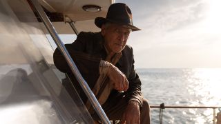 Still from the movie Indiana Jones and the Dial of Destiny. Here we see Indiana Jones casually leaning forward on a yacht.