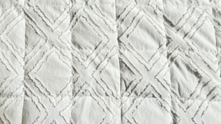 Close up image of the white material and the diamond shape pattern on YnM cooling bamboo weighted blanket