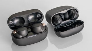 Sony WF-1000XM4 and Bose QuietComfort Earbuds II open cases next each other.