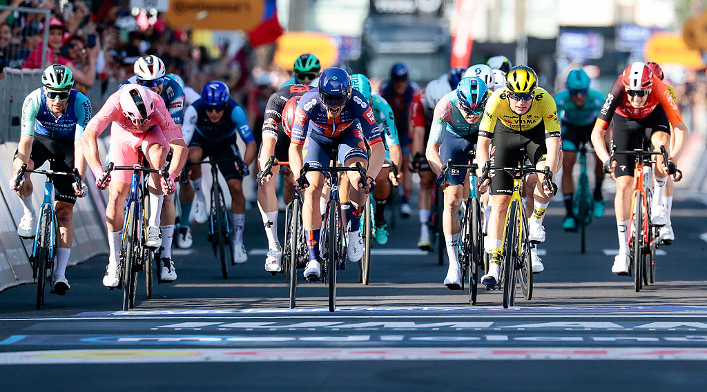 Team Picnic PostNL's Dutch rider Casper Van Uden (C) crosses the finish line of the 4th stage of the 108th Giro d'Italia cycling race 189kms from Alberobello to Lecce on May 13, 2025 (Photo by Luca Bettini / AFP)
