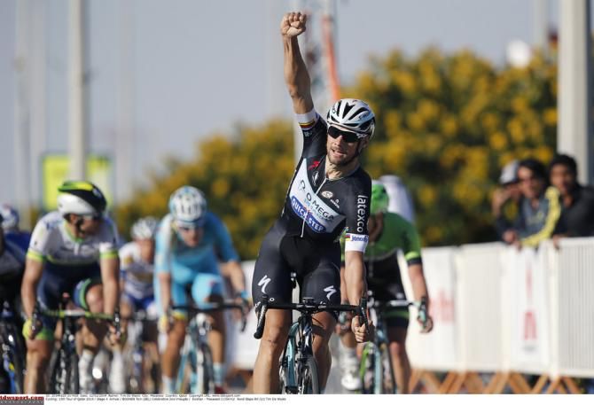 Tom Boonen crosses the line with his arm raised