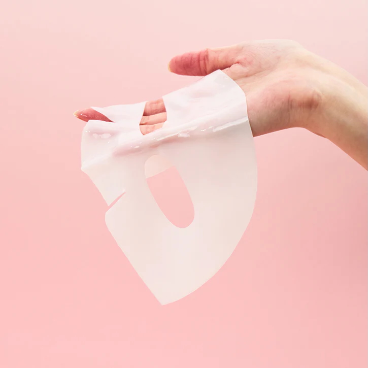 A woman holds a Biodance sheet mask in her hand