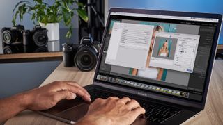 Man using Lightroom on laptop