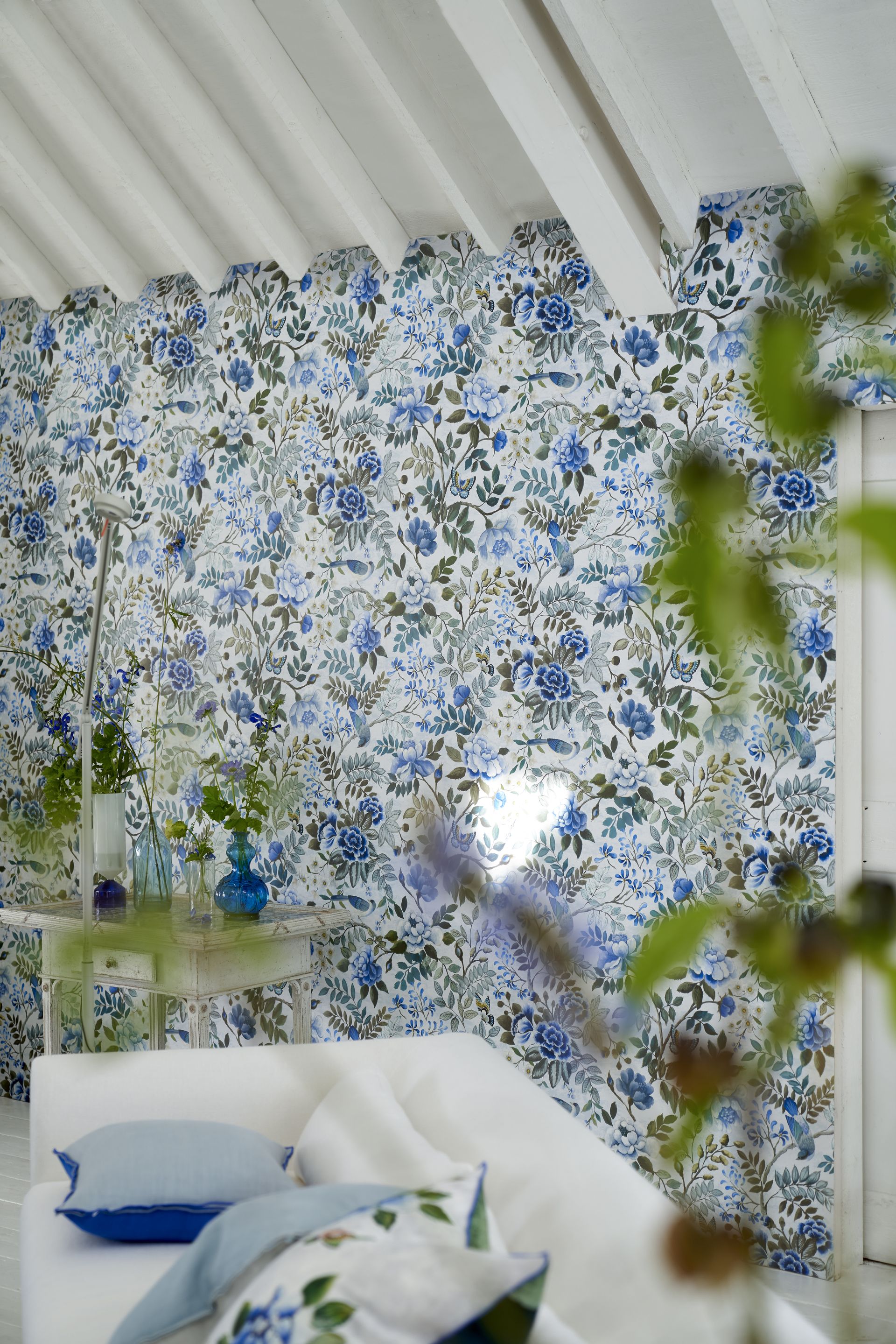 Blue green and white wallpaper, white sofa